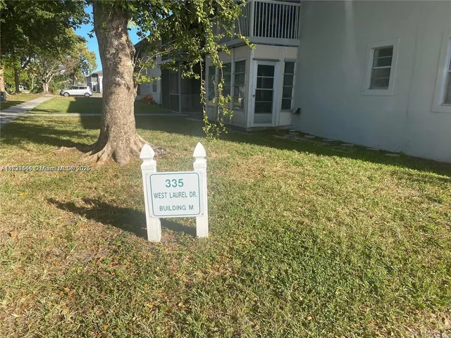 a sign board with yard in front of it
