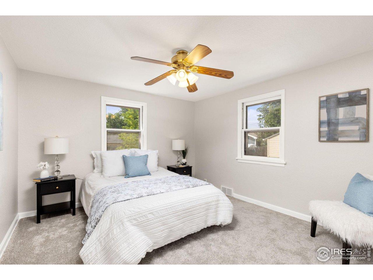 441 Sumner Street Longmont, CO 80501 - Photo 14 of 34 a bedroom with a bed and a chandelier