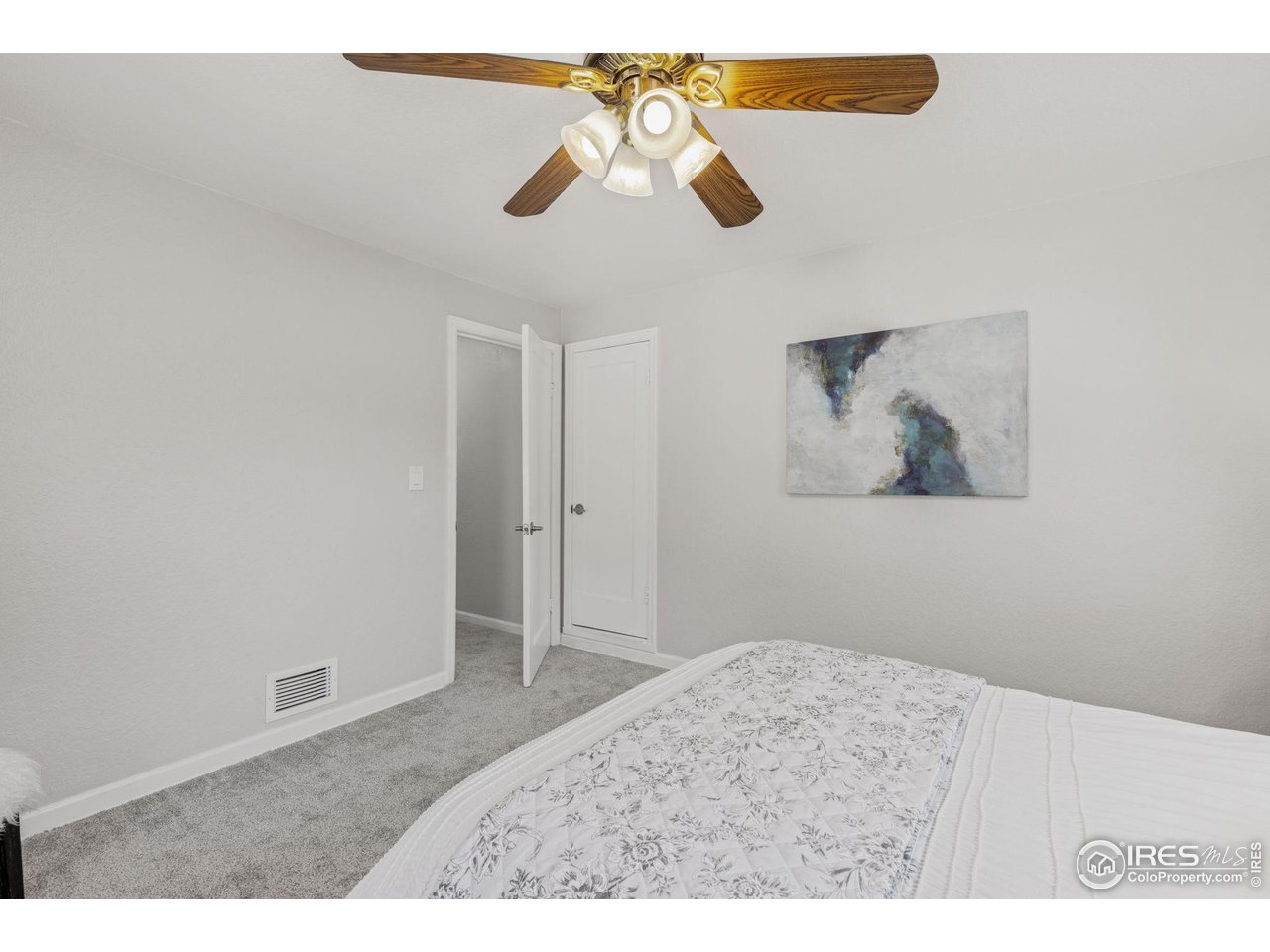 441 Sumner Street Longmont, CO 80501 - Photo 20 of 34 a bedroom with a bed and a chandelier