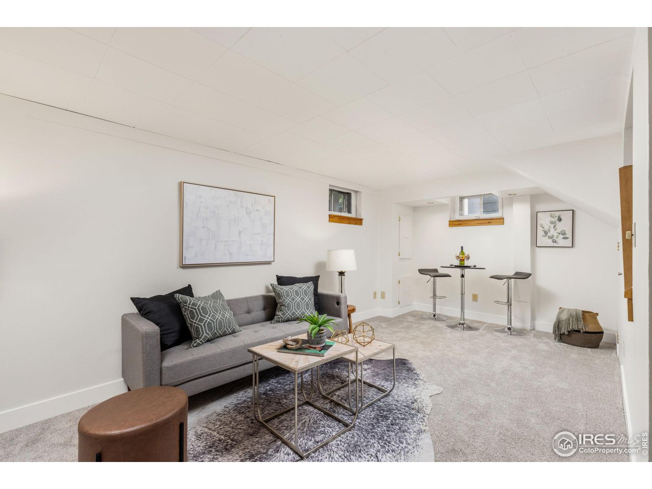441 Sumner Street Longmont, CO 80501 - Photo 21 of 34 a living room with furniture a rug and a lamp