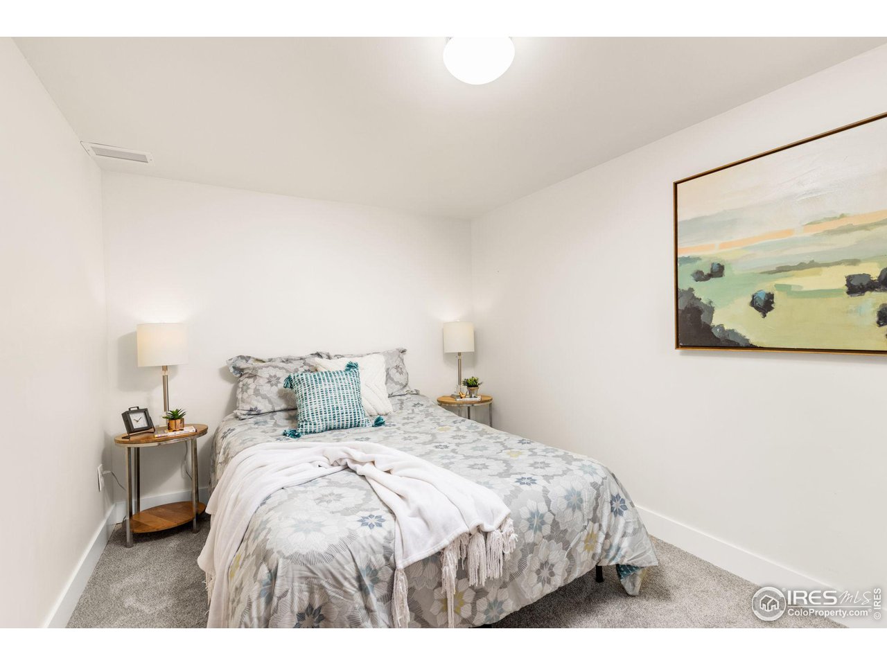 441 Sumner Street Longmont, CO 80501 - Photo 22 of 34 a bedroom with a bed and painting on the wall