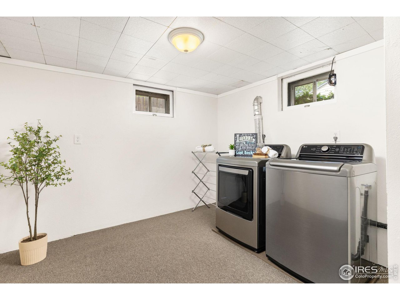 441 Sumner Street Longmont, CO 80501 - Photo 24 of 34 a utility room with cabinets washer and dryer