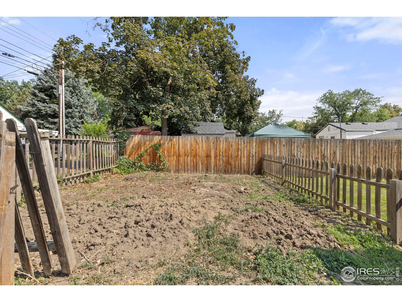 441 Sumner Street Longmont, CO 80501 - Photo 29 of 34 a view of a backyard with wooden fence