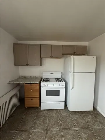 a kitchen with a sink a stove cabinets and counter space