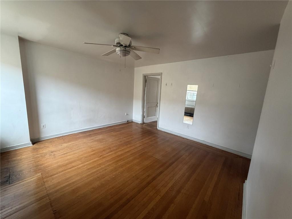 5839 Darlington Road, Unit 4 Pittsburgh, PA 15217 - Photo 17 of 21 wooden floor in an empty room with a window