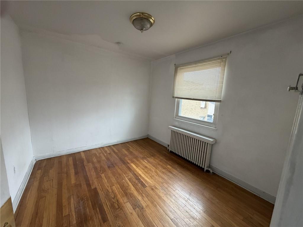 5839 Darlington Road, Unit 4 Pittsburgh, PA 15217 - Photo 20 of 21 an empty room with wooden floor and windows