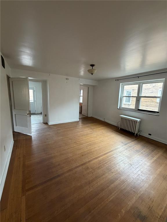 5839 Darlington Road, Unit 4 Pittsburgh, PA 15217 - Photo 6 of 21 an empty room with wooden floor and windows