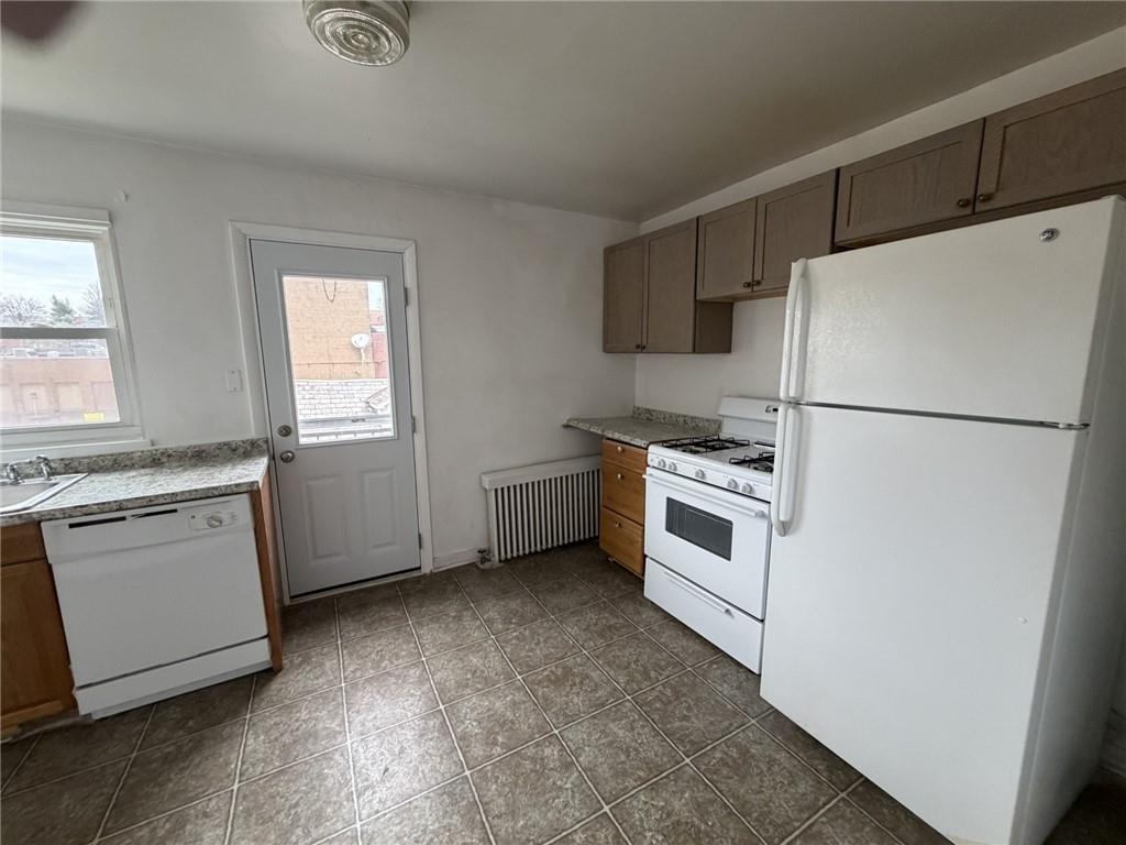 5839 Darlington Road, Unit 4 Pittsburgh, PA 15217 - Photo 10 of 21 a kitchen with white cabinets and white appliances