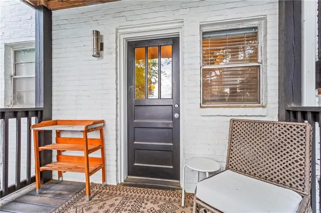 a bathroom with a toilet a window and shower