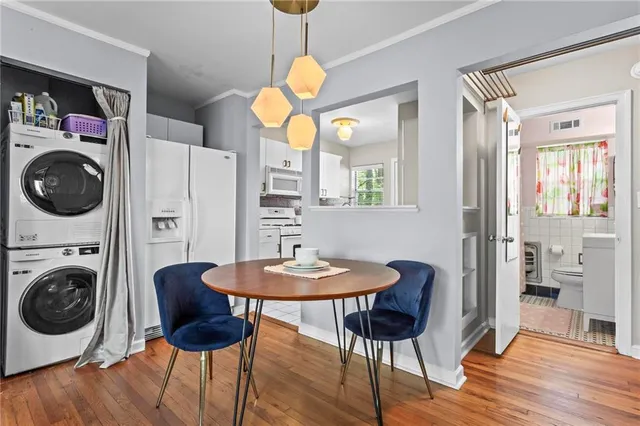 a view of a dining room with furniture a chandelier and wooden floor