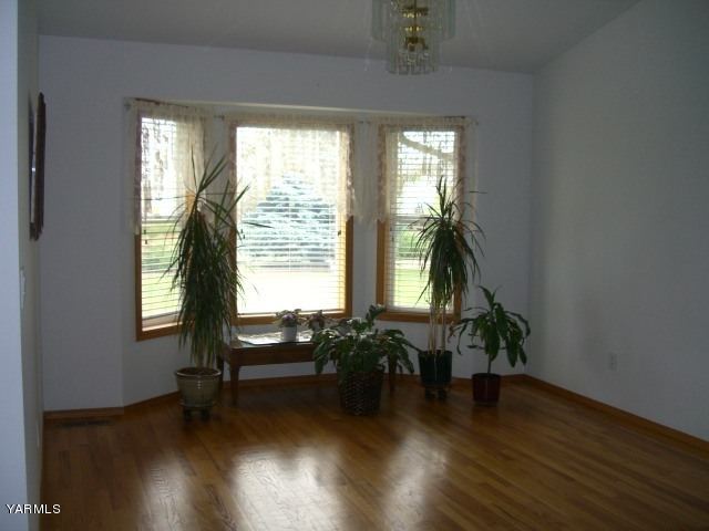 3303 Wiley Road Yakima, WA 98903 - Photo 6 of 9 wooden floor in an empty room with a window