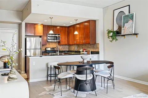a kitchen with a table chairs and entryway
