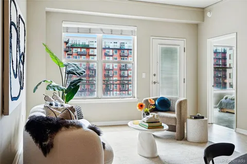 a living room with furniture and a book shelf