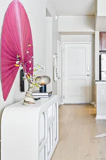 a kitchen with a sink a refrigerator and cabinets
