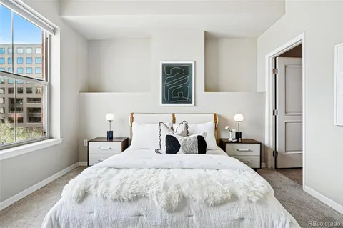 a bedroom with bed and window