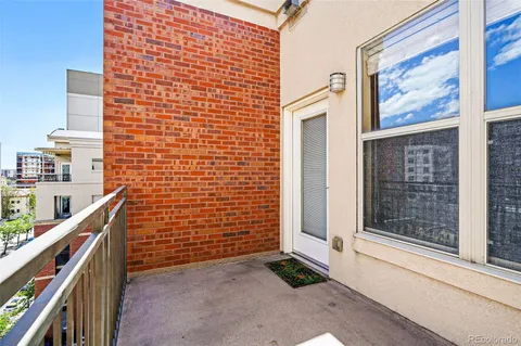 a view of a hallway with closet and wooden floor