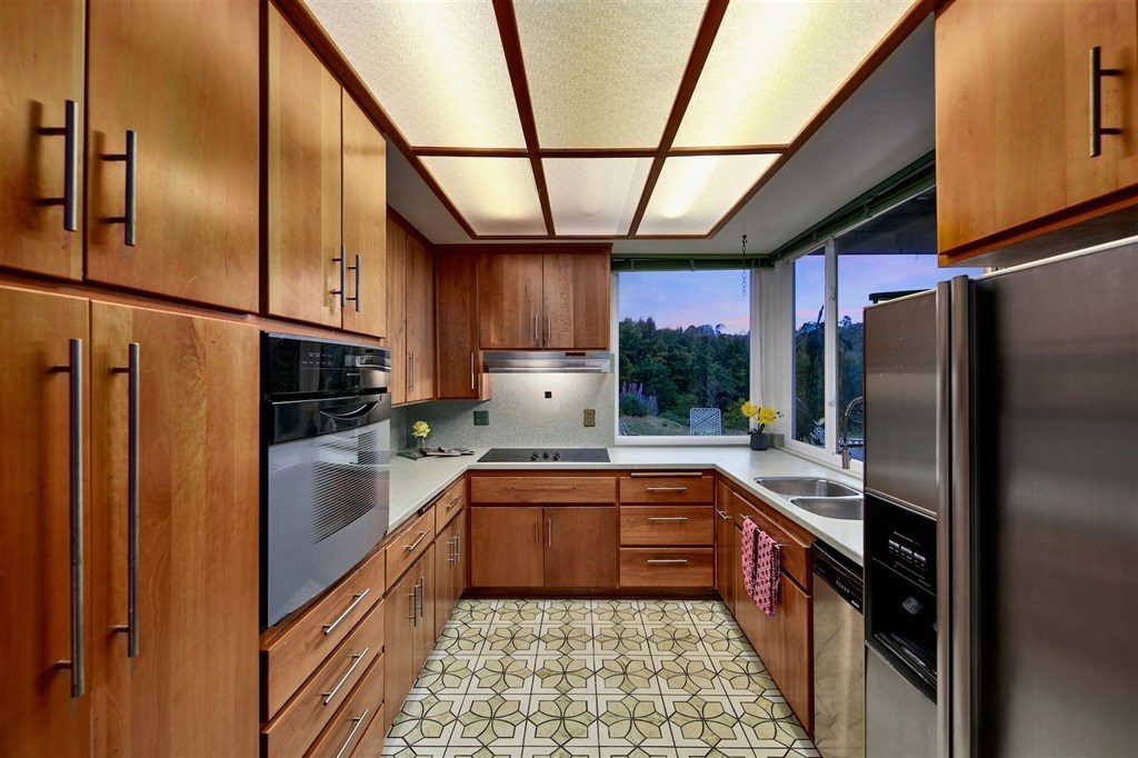 15022 Paso Del Sol Del Mar, CA 92014 - Photo 8 of 25 a kitchen with stainless steel appliances granite countertop a refrigerator a sink and wooden cabinets