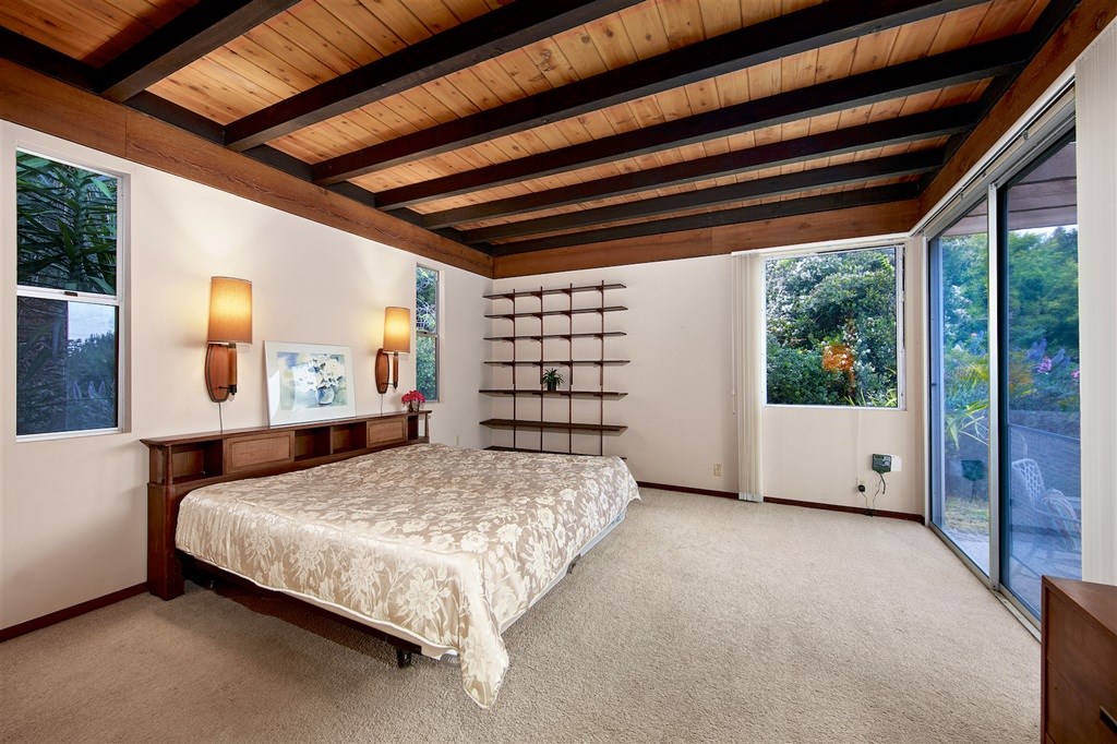 15022 Paso Del Sol Del Mar, CA 92014 - Photo 10 of 25 a bedroom with a large bed and a large window with outer view