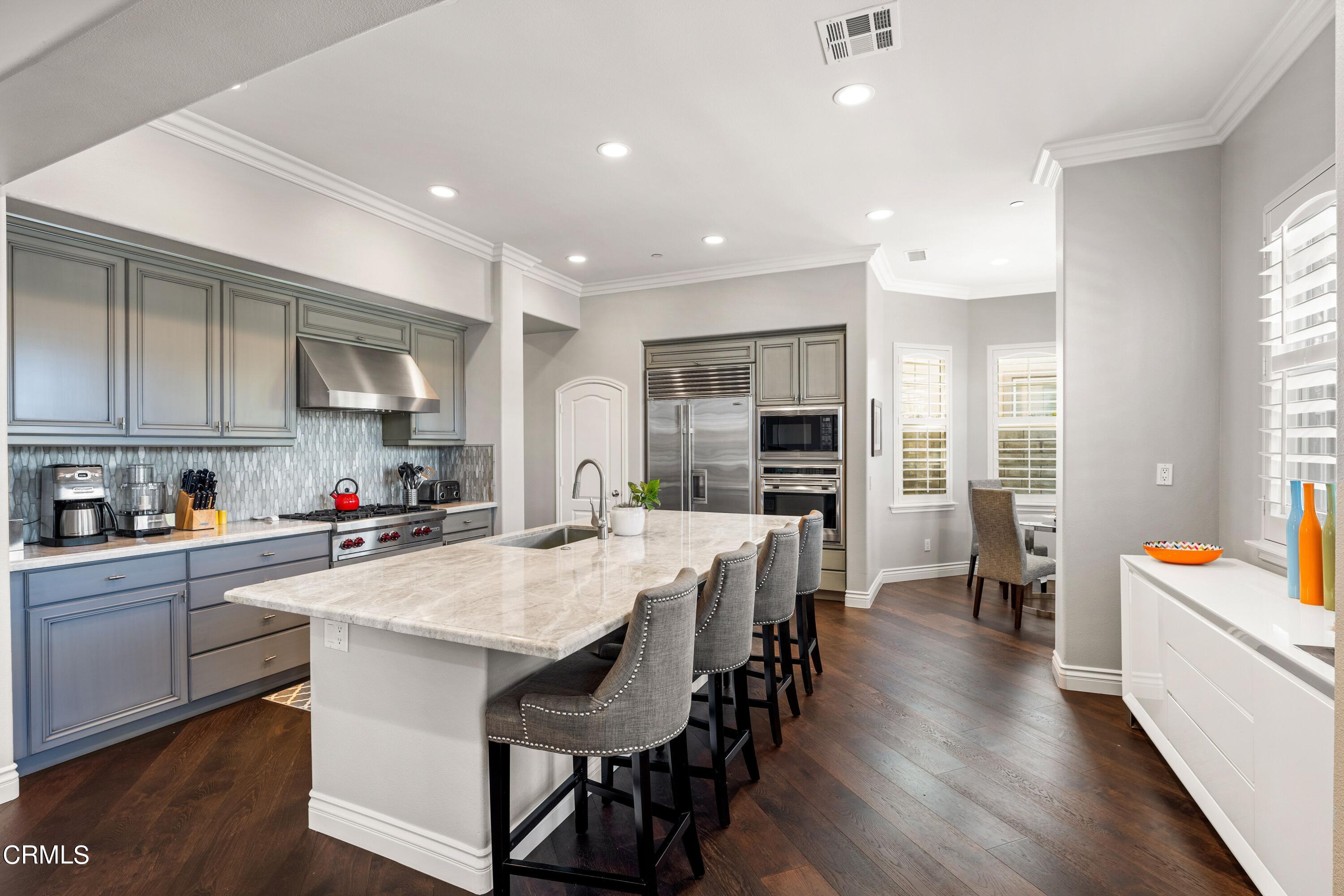 1544 Twin Tides Place Oxnard, CA 93035 - Photo 15 of 49 a large kitchen with a table and chairs in it
