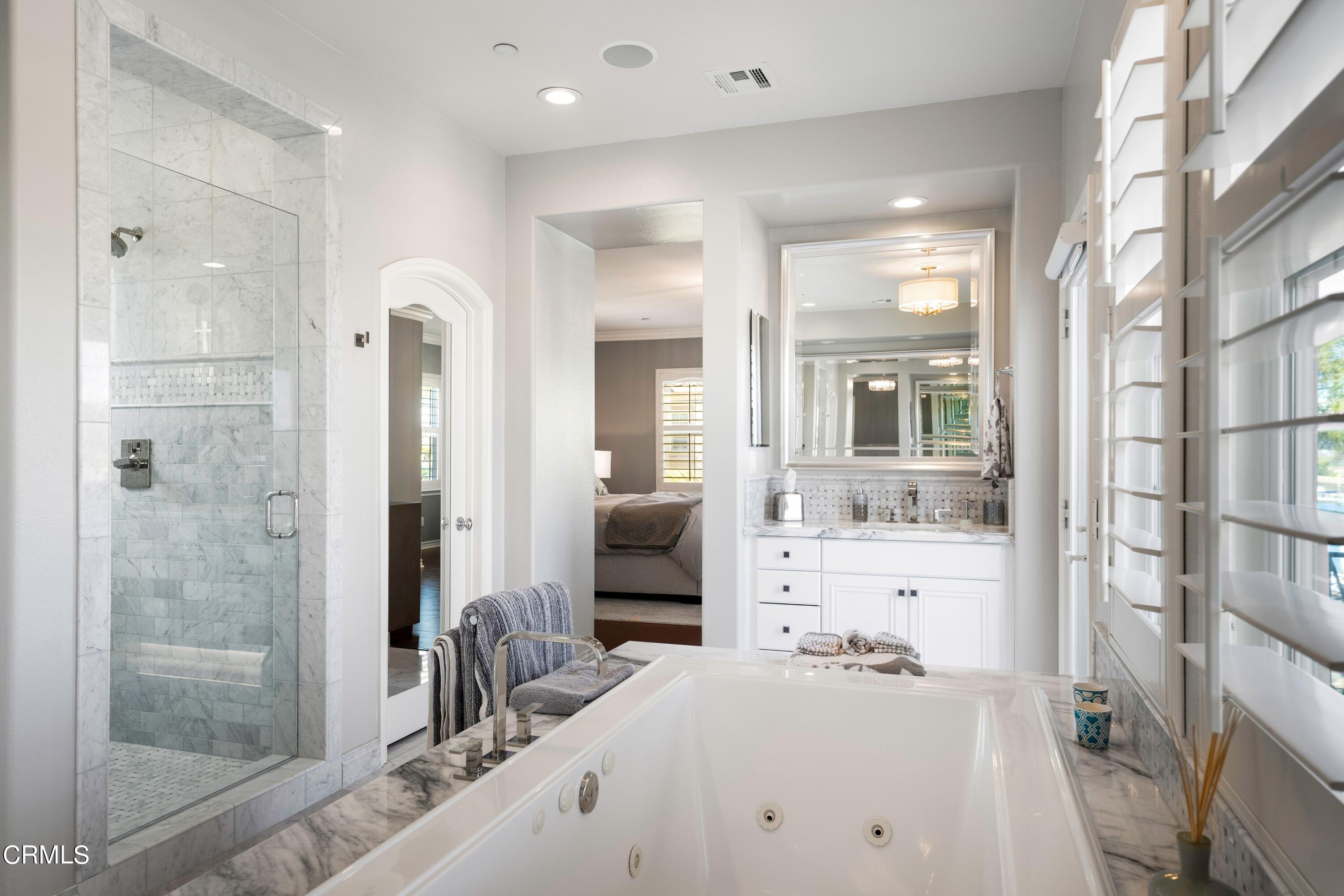 1544 Twin Tides Place Oxnard, CA 93035 - Photo 30 of 49 a bathroom with a tub sink and mirror