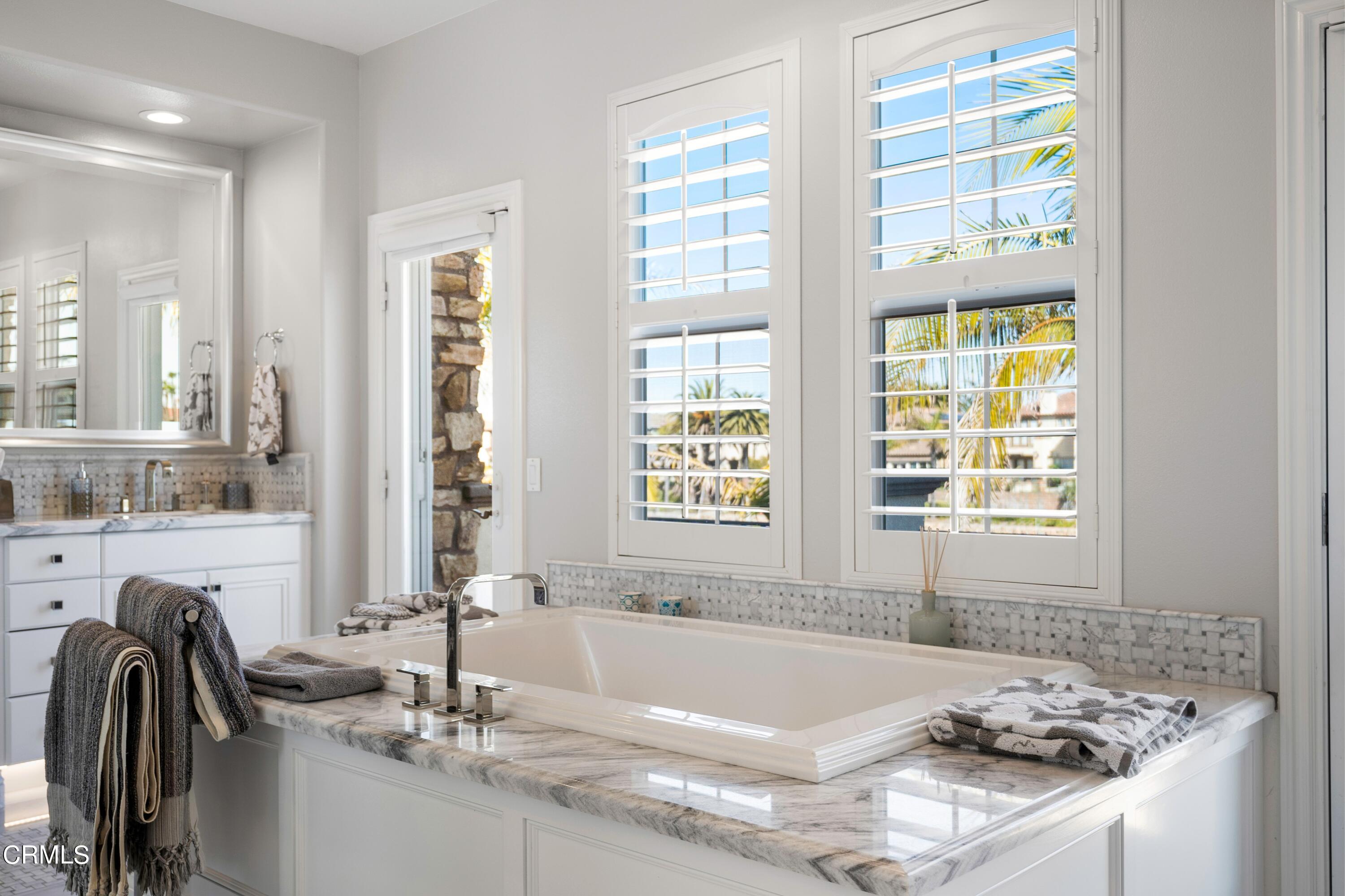 1544 Twin Tides Place Oxnard, CA 93035 - Photo 31 of 49 a bath tub sitting in a bathroom next to a window