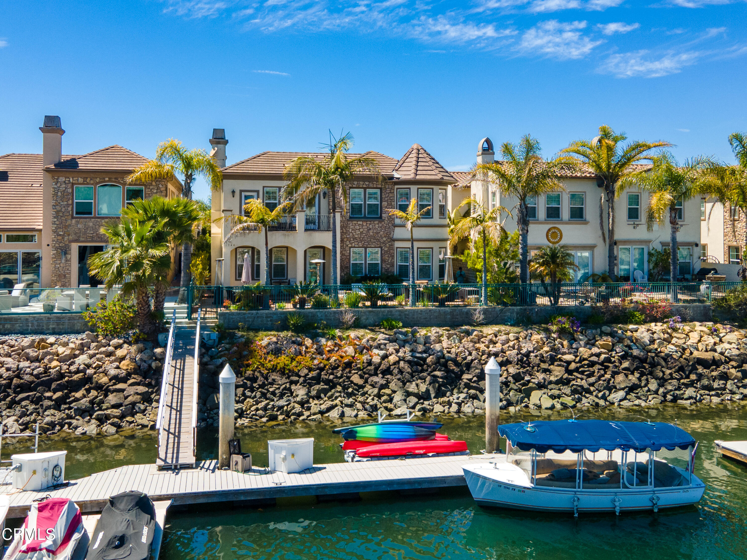 1544 Twin Tides Place Oxnard, CA 93035 - Photo 43 of 49 a front view of a house with a garden and plants