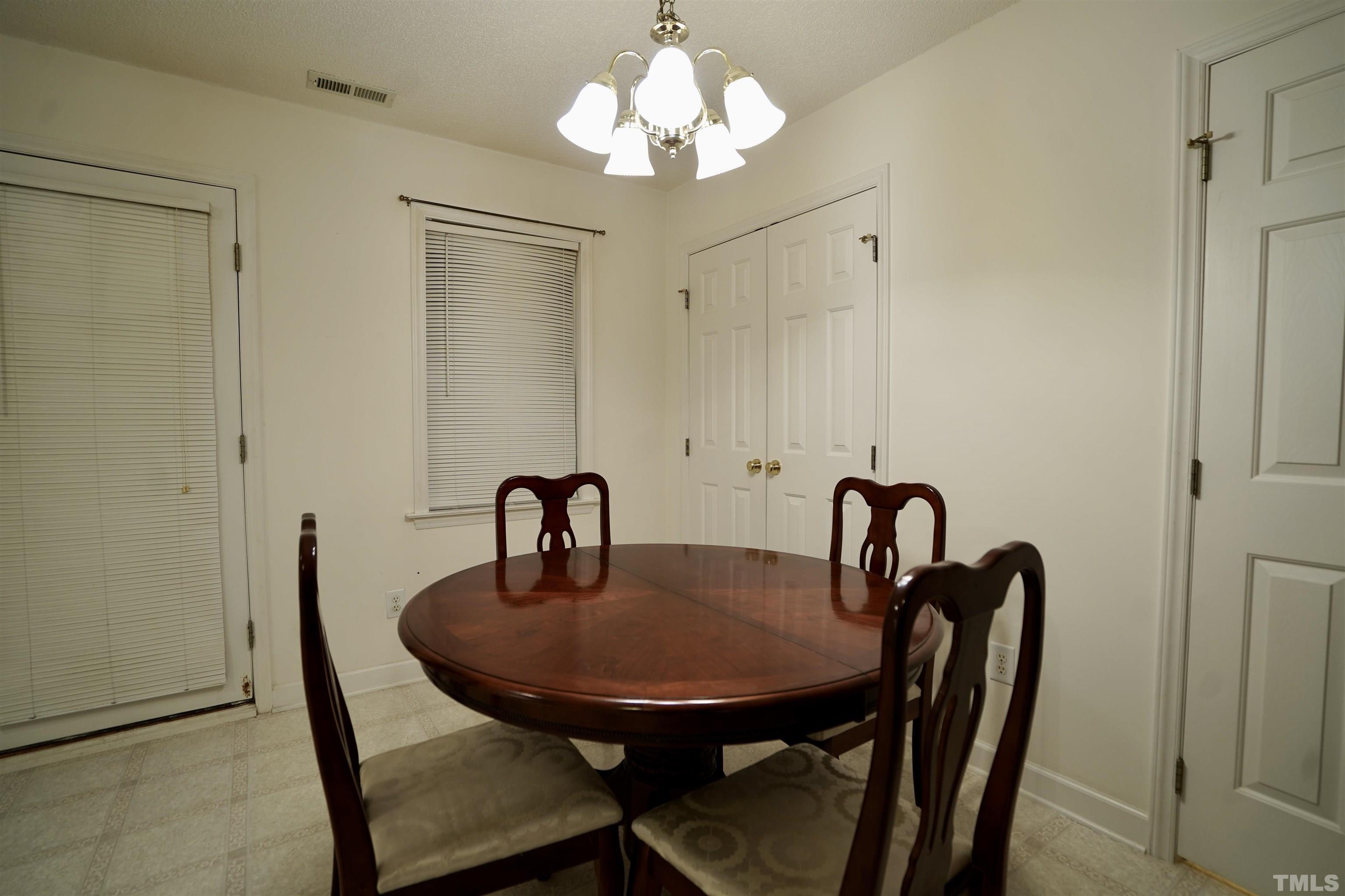 5102 Twisted Willow Way Raleigh, NC 27610 - Photo 6 of 12 a dining room with furniture and chandelier
