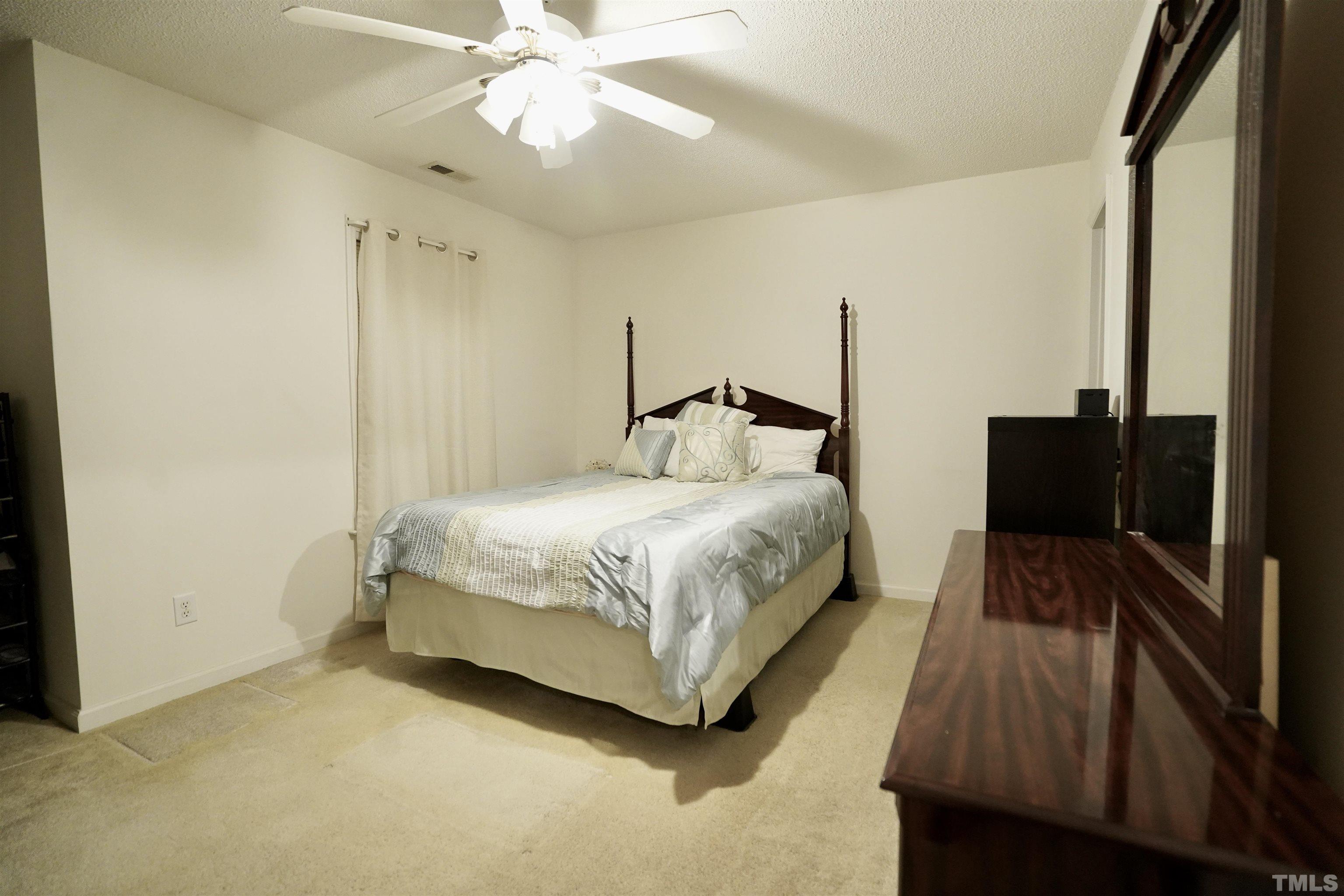 5102 Twisted Willow Way Raleigh, NC 27610 - Photo 7 of 12 a bedroom with a bed and a walk in closet