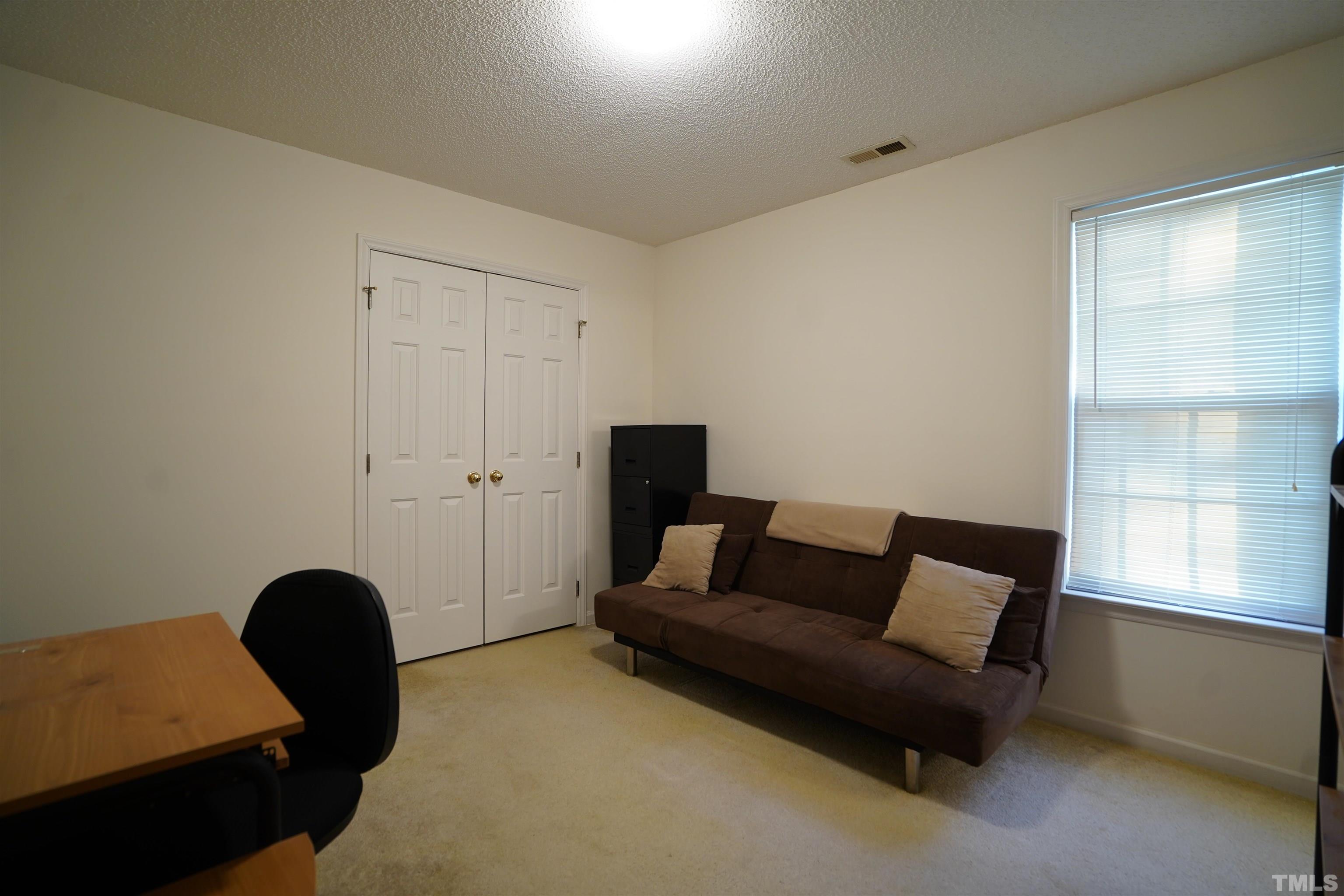 5102 Twisted Willow Way Raleigh, NC 27610 - Photo 8 of 12 a living room with furniture and a window