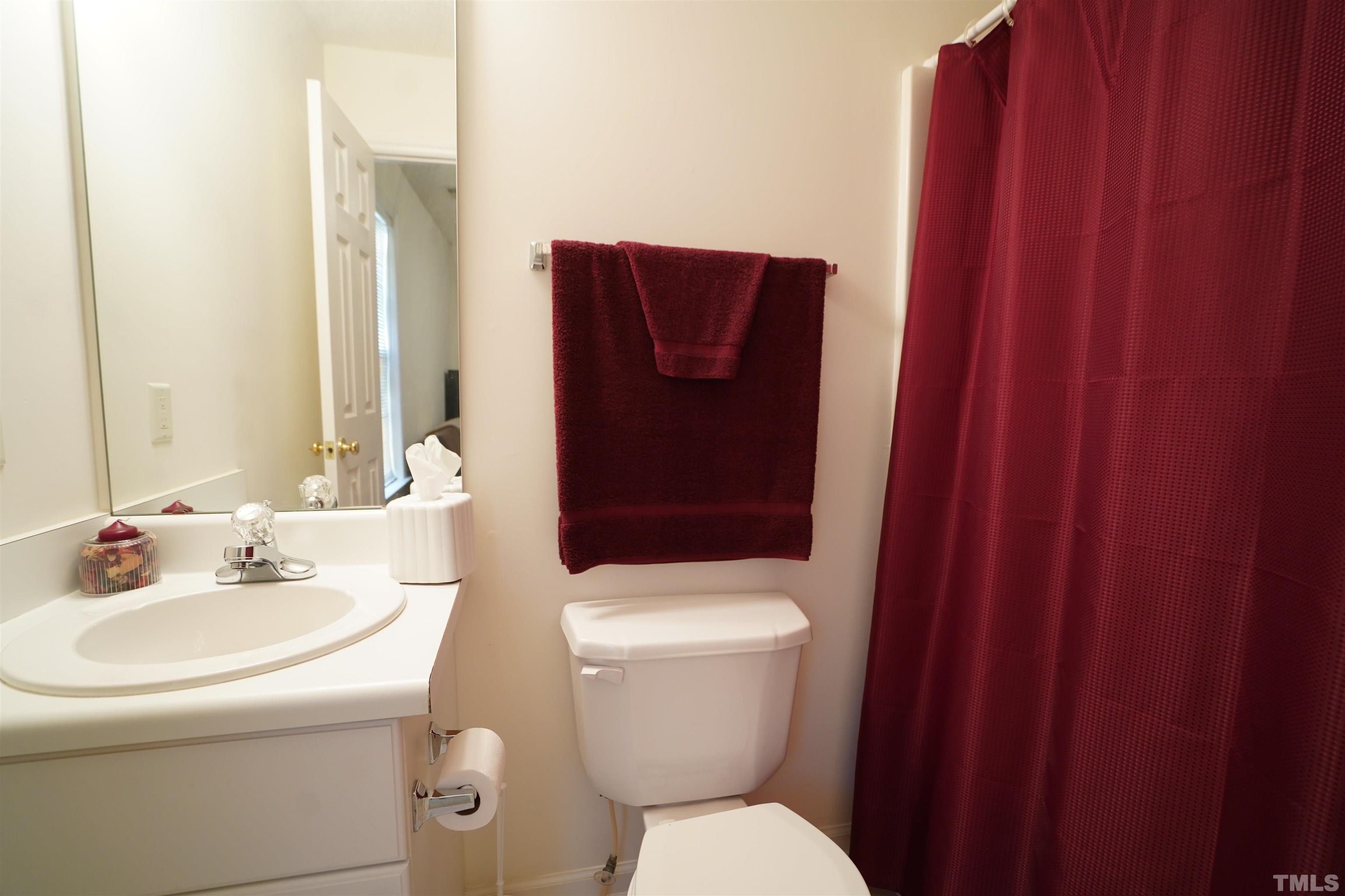 5102 Twisted Willow Way Raleigh, NC 27610 - Photo 9 of 12 a bathroom with a toilet sink and mirror