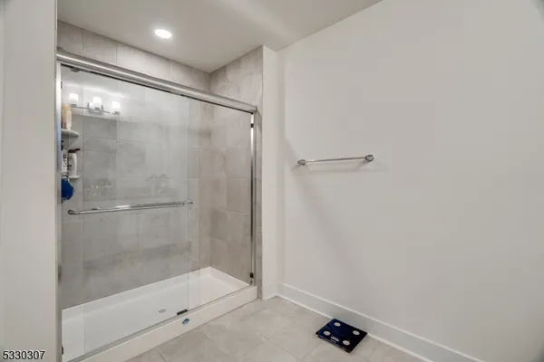 a bathroom with a glass shower door