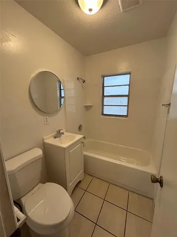 a bathroom with a toilet a sink and bathtub