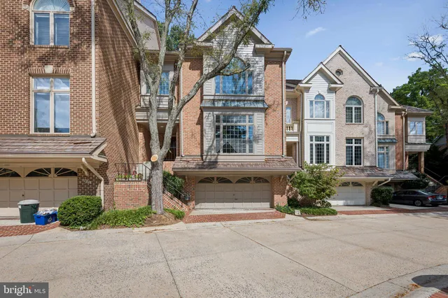 a living room with fireplace furniture and a large window