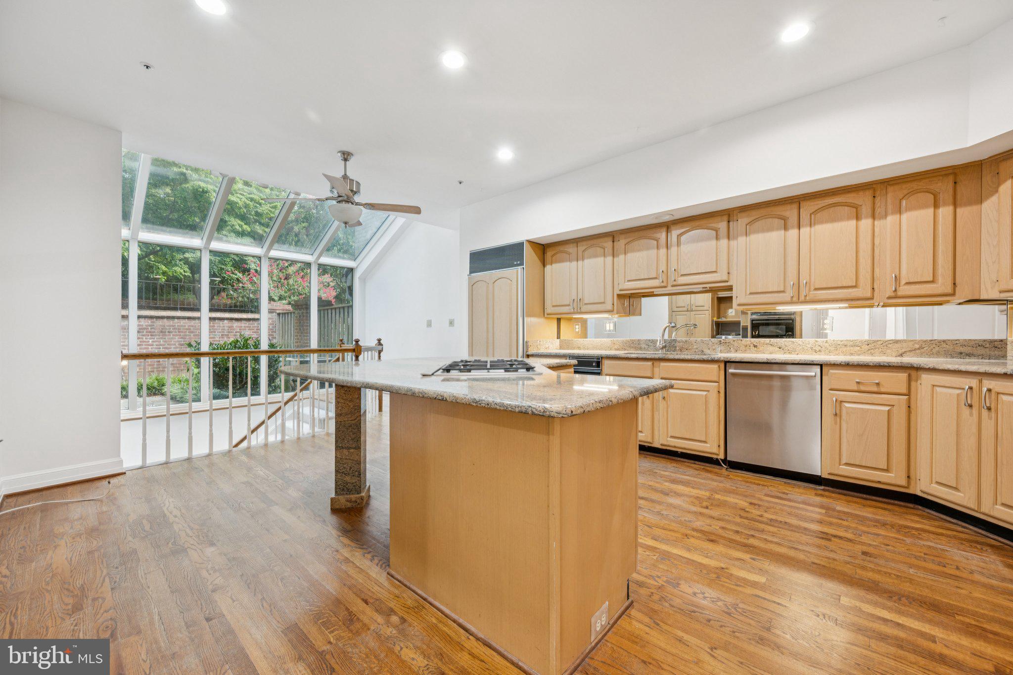 5819 Madaket Road Bethesda, MD 20816 - Photo 11 of 50 a large kitchen with kitchen island a sink wooden floor and counter space