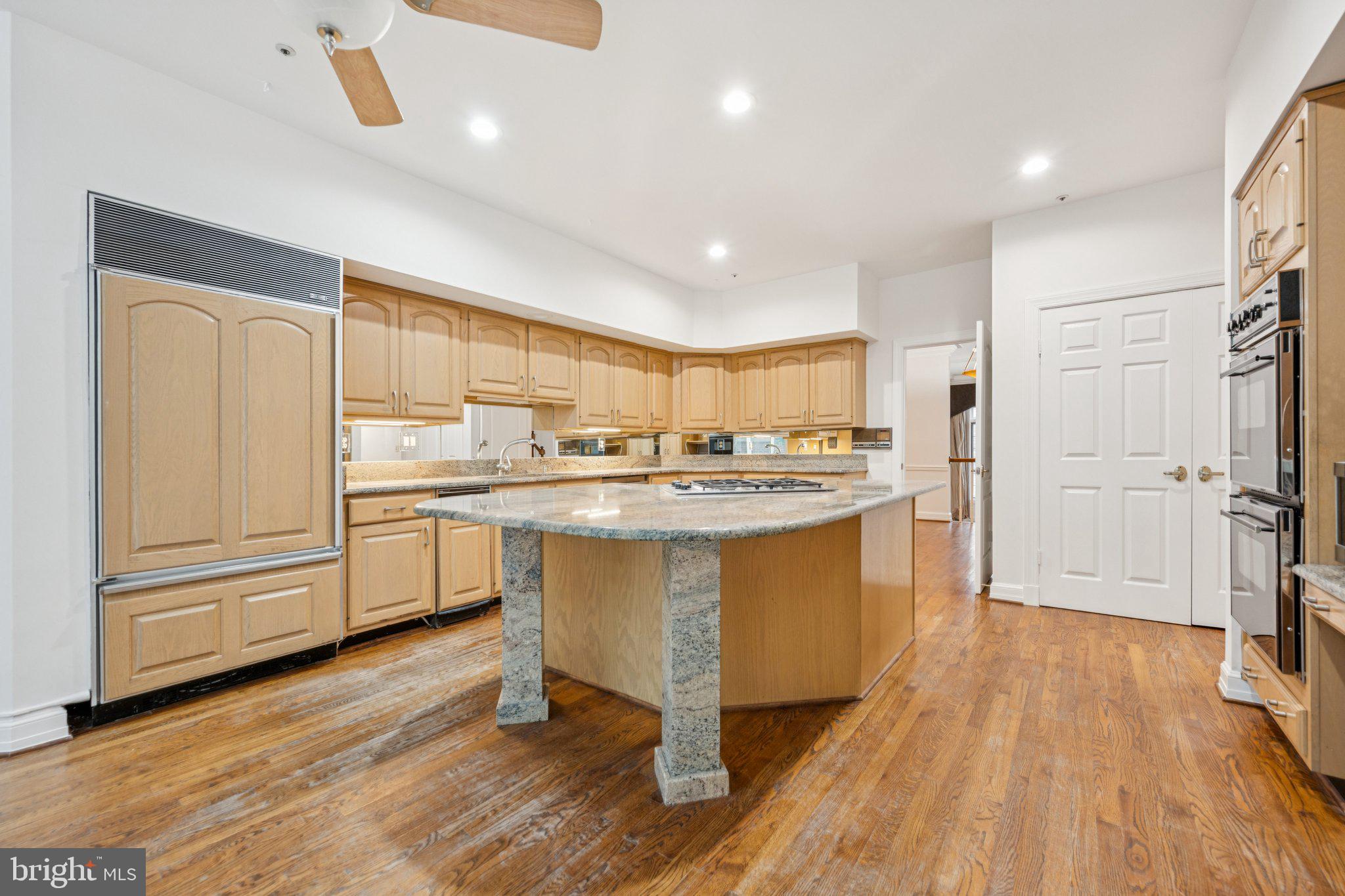 5819 Madaket Road Bethesda, MD 20816 - Photo 12 of 50 a kitchen with white cabinets and sink