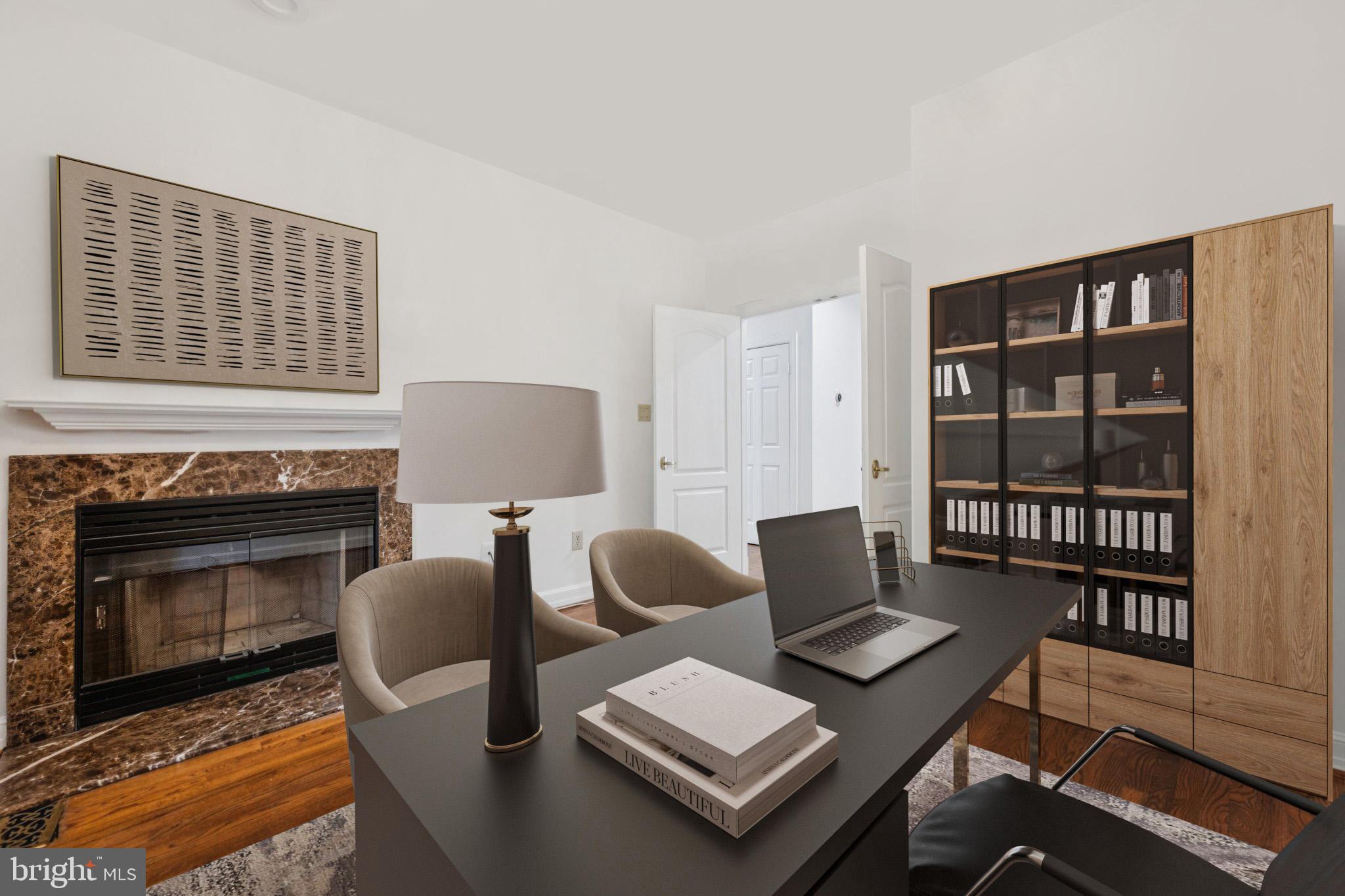 5819 Madaket Road Bethesda, MD 20816 - Photo 17 of 50 a living room with furniture a rug and a fireplace