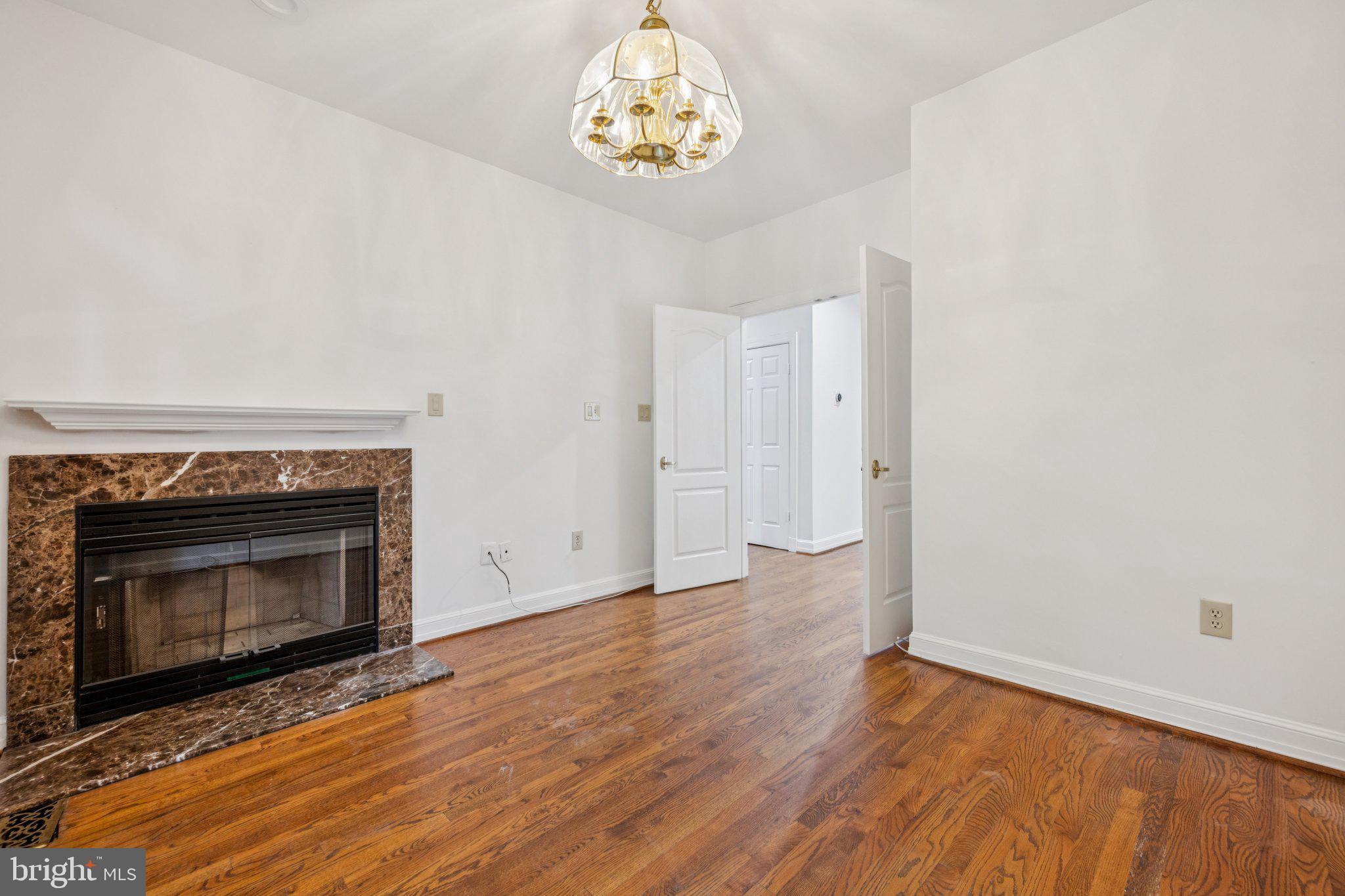 5819 Madaket Road Bethesda, MD 20816 - Photo 18 of 50 a view of an empty room with wooden floor and a fireplace