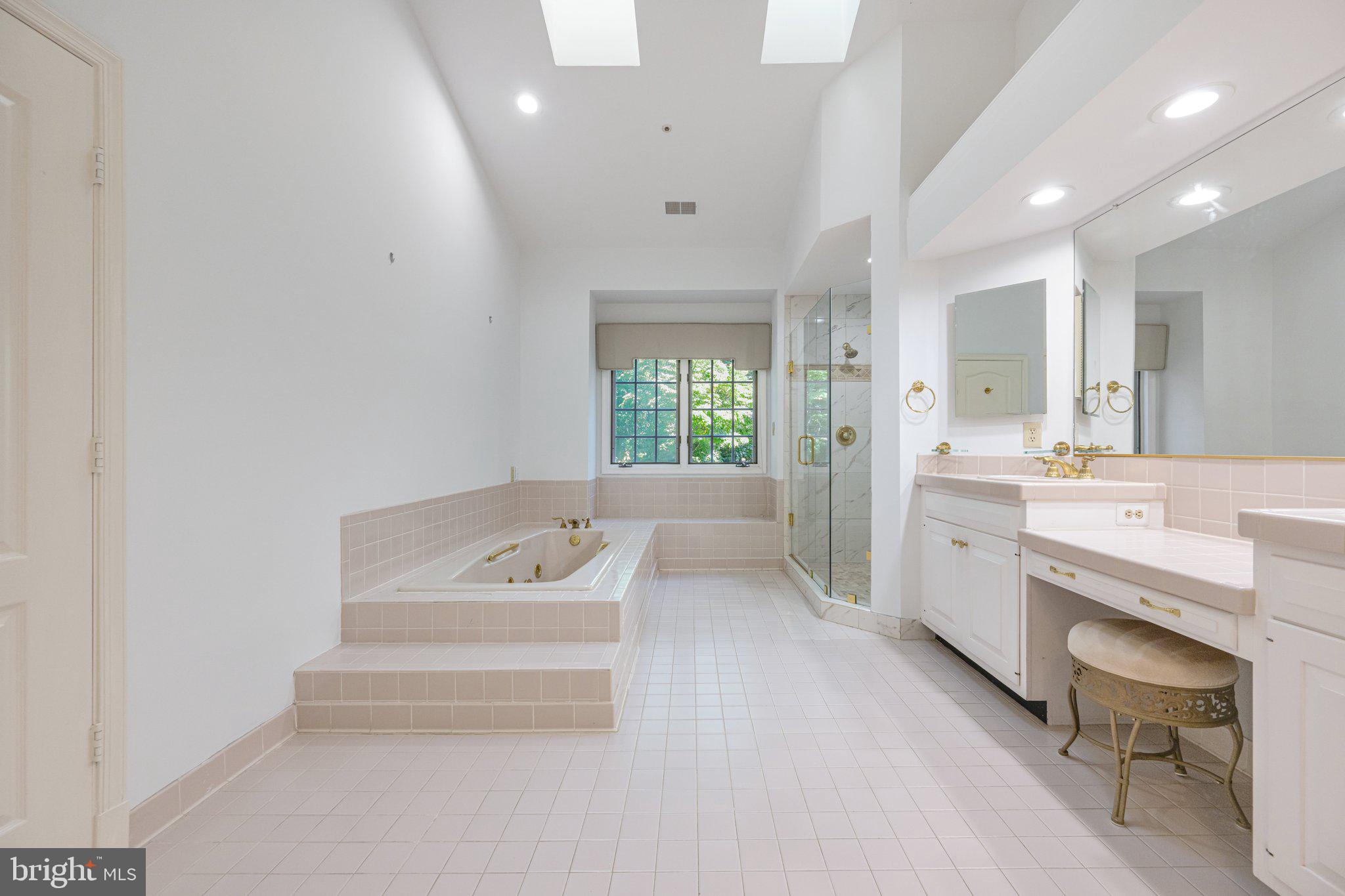 5819 Madaket Road Bethesda, MD 20816 - Photo 23 of 50 a bathroom with a sink a tub and a shower