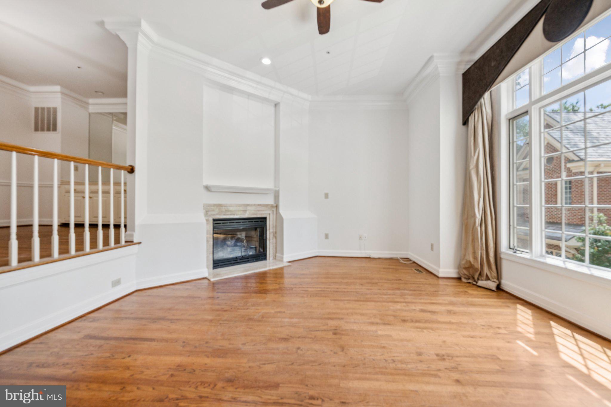 5819 Madaket Road Bethesda, MD 20816 - Photo 3 of 50 a view of an empty room with a window and fireplace
