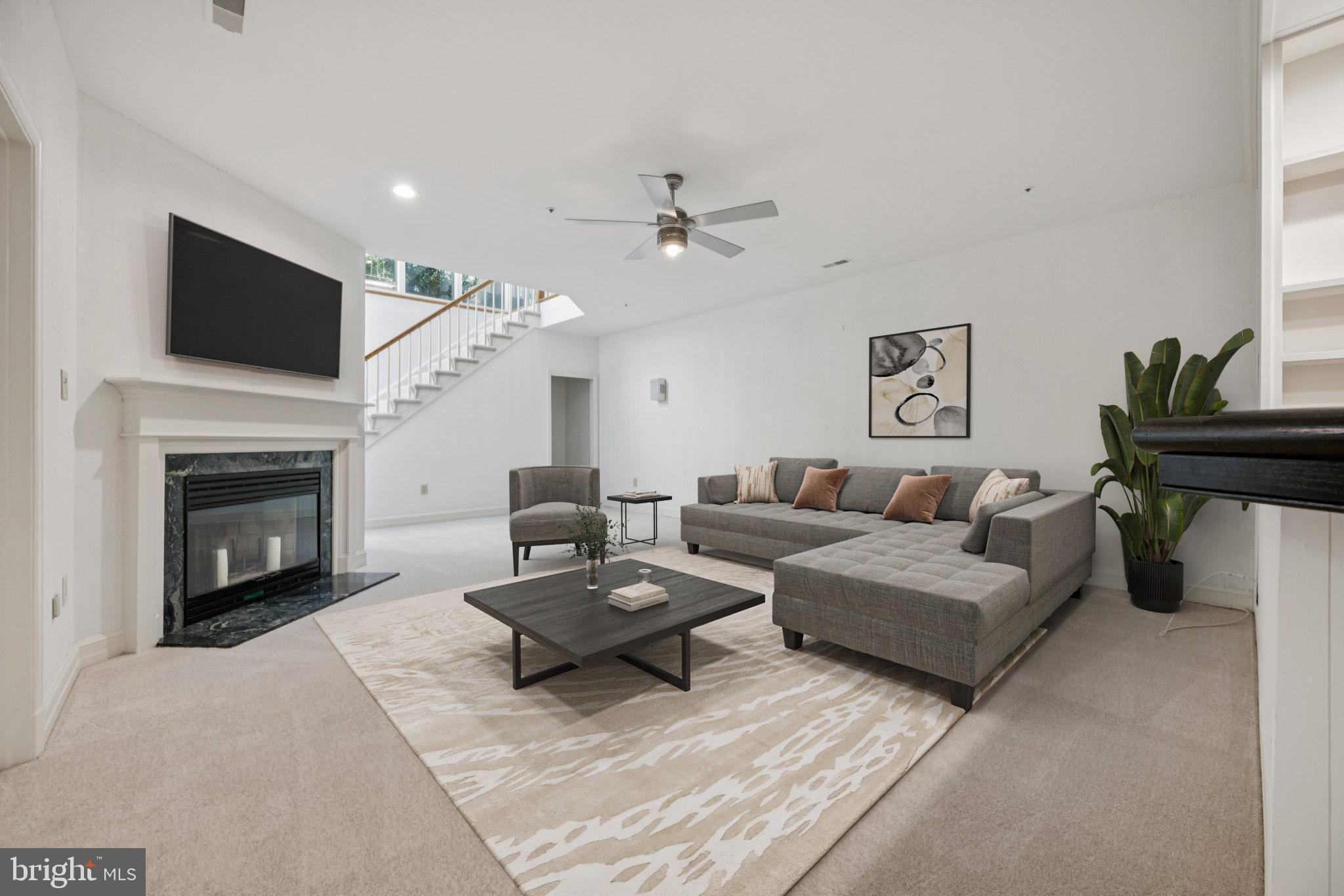 5819 Madaket Road Bethesda, MD 20816 - Photo 33 of 50 a living room with furniture a fireplace and a flat screen tv