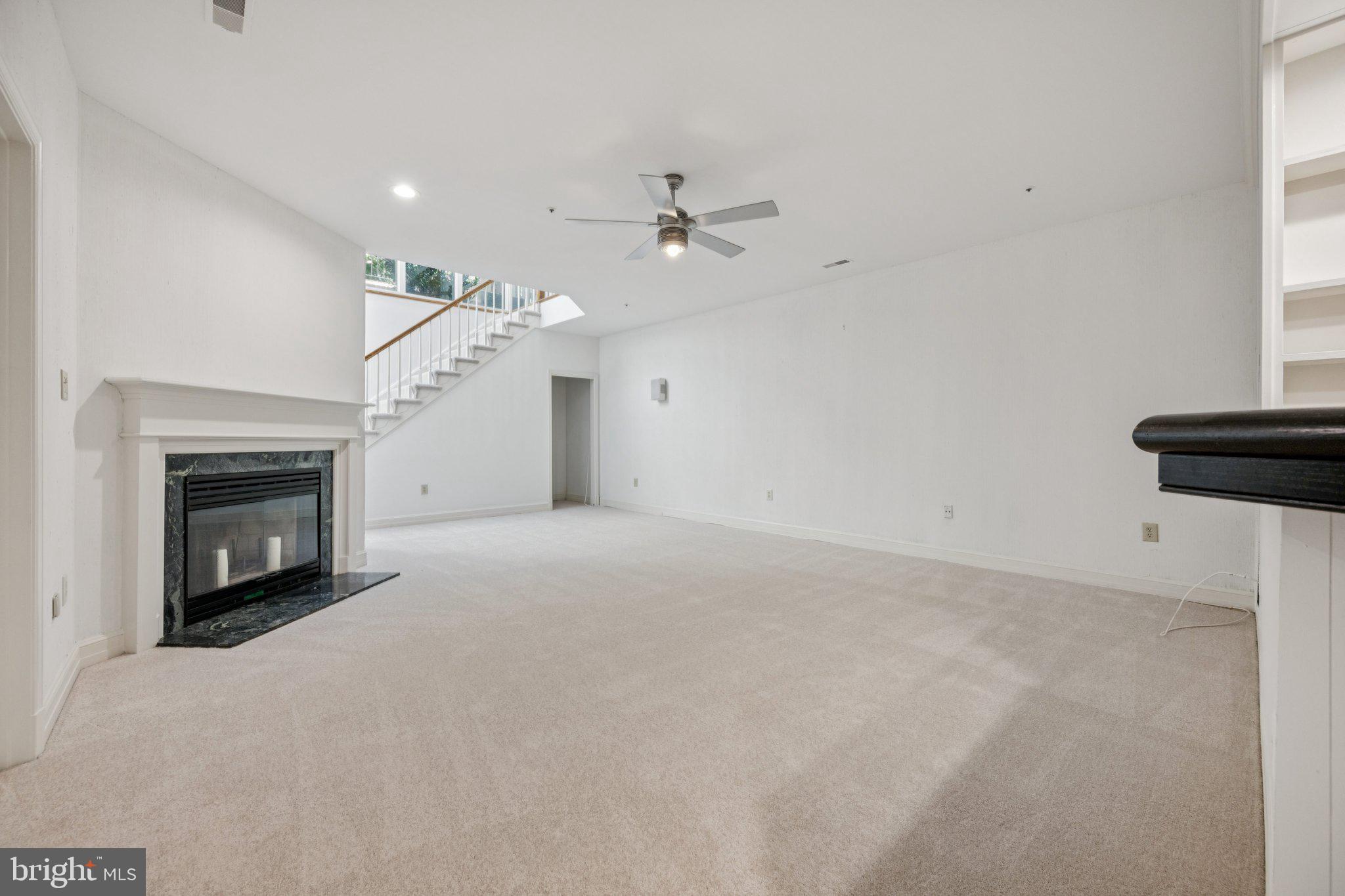 5819 Madaket Road Bethesda, MD 20816 - Photo 34 of 50 an empty room with fireplace and fan