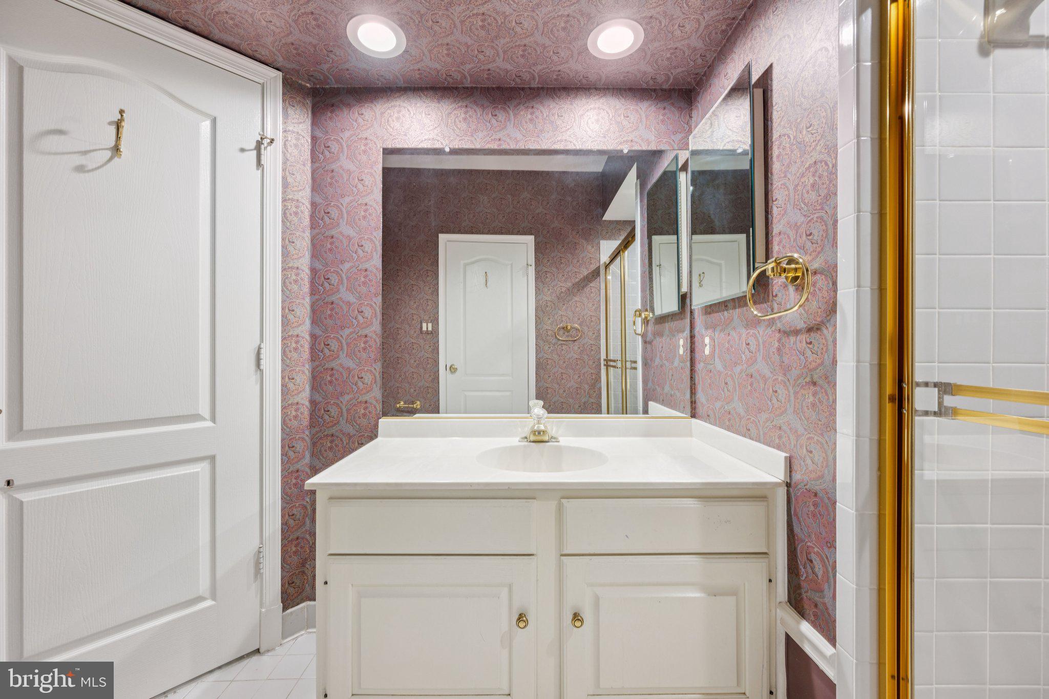 5819 Madaket Road Bethesda, MD 20816 - Photo 41 of 50 a bathroom with a sink vanity and a mirror