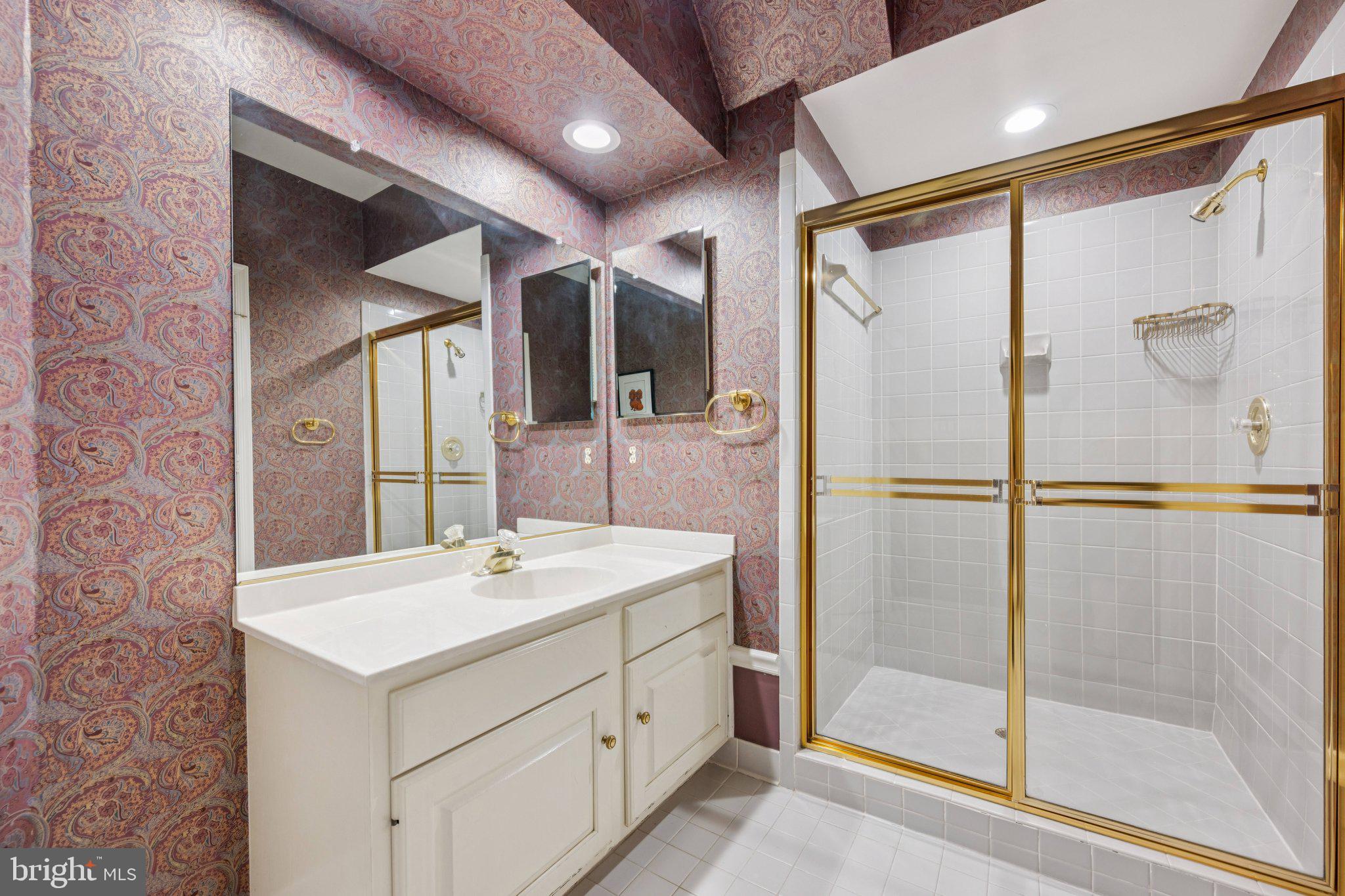 5819 Madaket Road Bethesda, MD 20816 - Photo 42 of 50 a bathroom with a shower sink and mirror