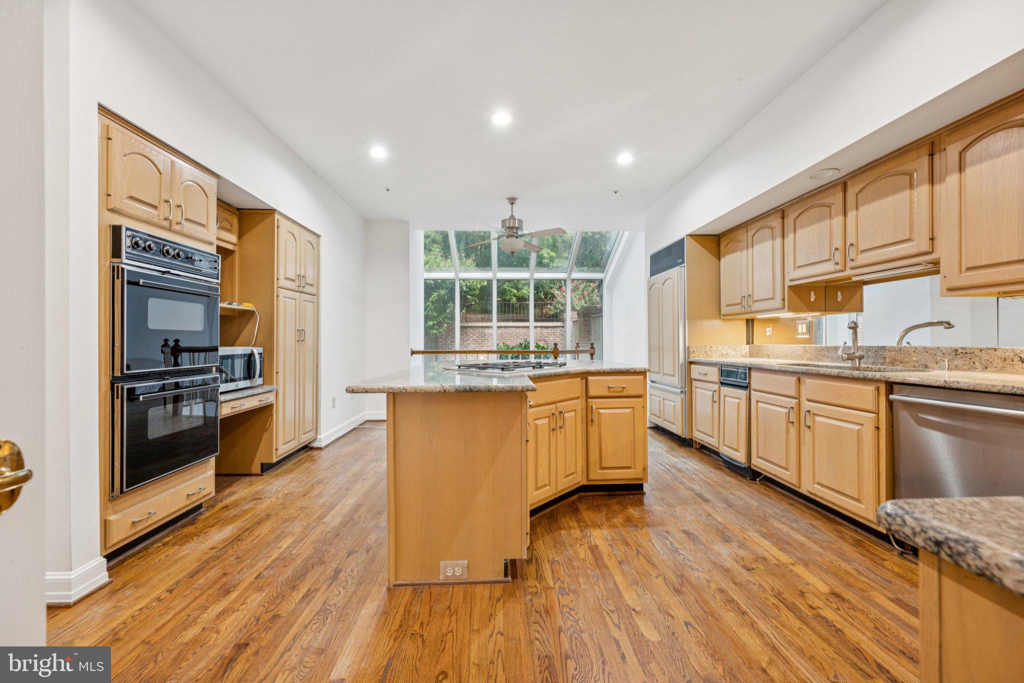 5819 Madaket Road Bethesda, MD 20816 - Photo 10 of 50 a kitchen with stainless steel appliances granite countertop a stove and a wooden floors