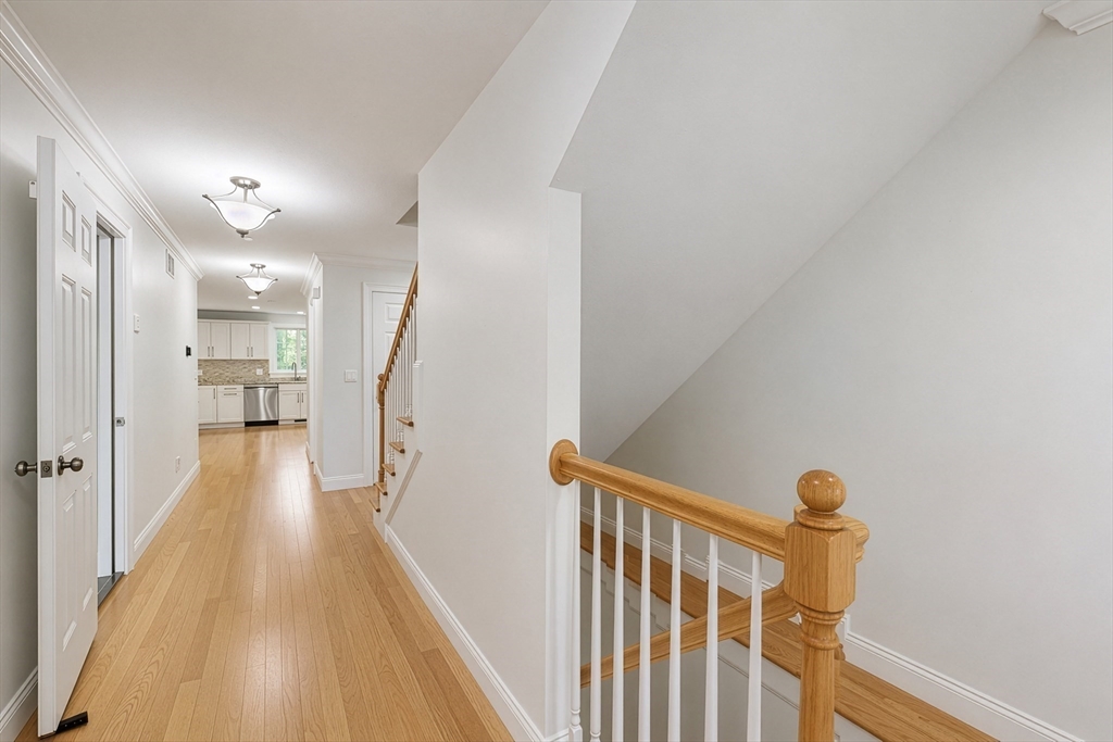 215 Rangeway Road, Unit 31 Billerica, MA 01862 - Photo 6 of 40 a view of a hallway with wooden floor and staircase