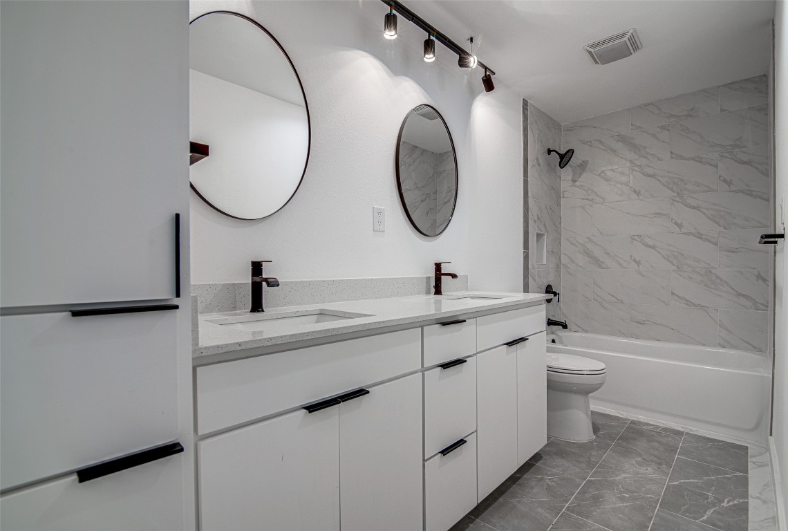207 Haley Road Johnson City, TX 78636 - Photo 13 of 26 a bathroom with a sink a toilet and a mirror