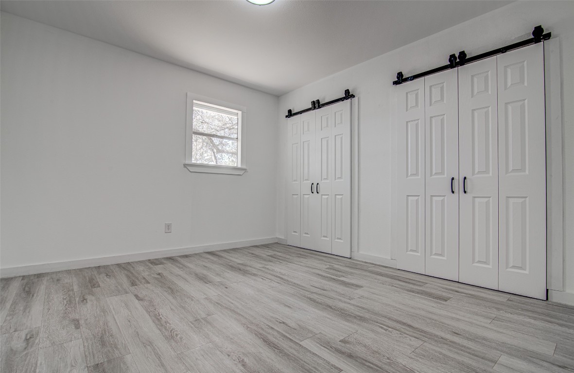 207 Haley Road Johnson City, TX 78636 - Photo 15 of 26 a view of an empty room with wooden floor