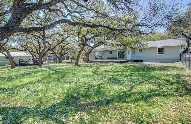 a house that has a tree in front of it