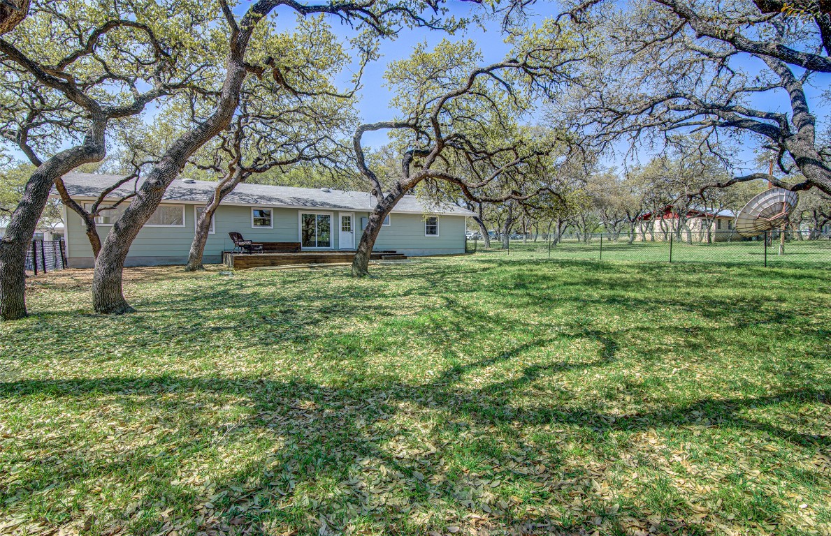 207 Haley Road Johnson City, TX 78636 - Photo 23 of 26 a yellow house in middle of a field