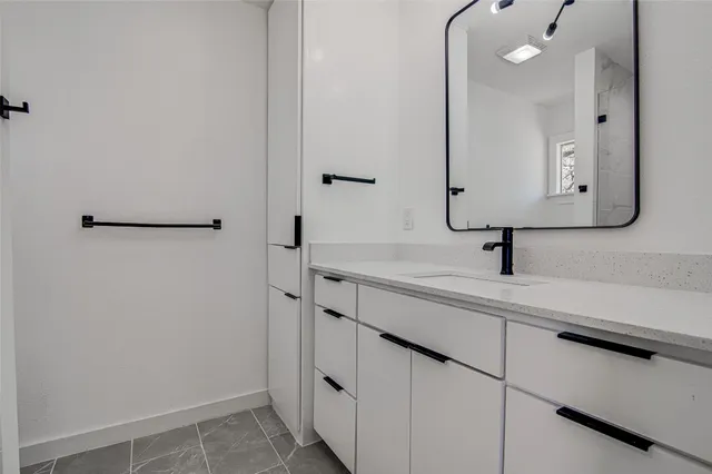 a bathroom with a sink and mirror